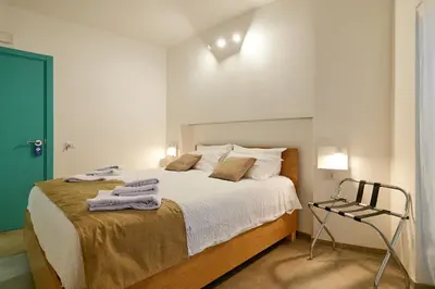 a bedroom with a large bed with towels on it at La casa di Chele in Palermo