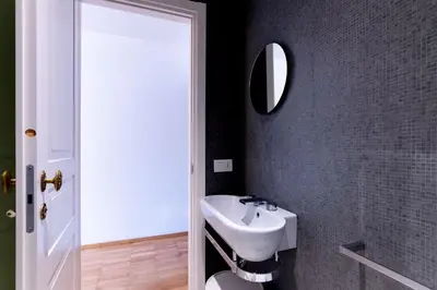 a bathroom with a sink and a mirror at Appartamento Al Genio in Palermo