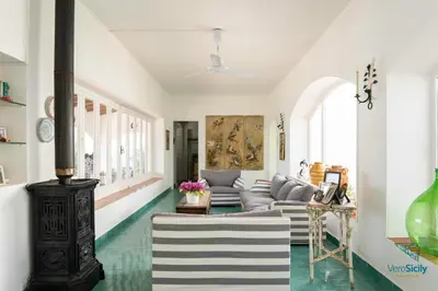 a living room with a couch and a fireplace at Villa Giacona Venuti in Terrasini