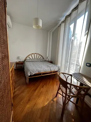 a bedroom with a bed and a table and a window at A casa del Conte in Palermo