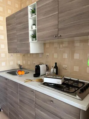 a kitchen with a sink and a stove top oven at Casa Conturrana,10 metri dalla spiaggia di San Vito in San Vito lo Capo