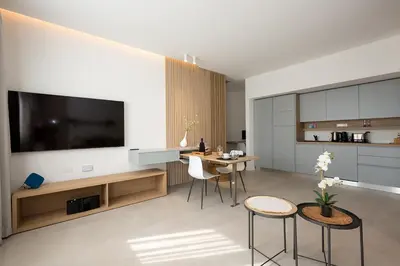 a living room with a television and a table and chairs at Giada Luxury Terrasini in Terrasini