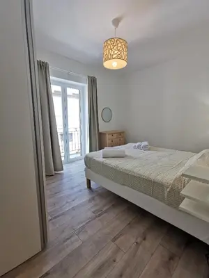 a bedroom with a bed and a large window at Dagnino House - Luxury apartment in the center of Palermo in Palermo