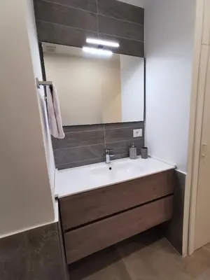 a bathroom with a sink and a mirror at Dagnino House - Luxury apartment in the center of Palermo in Palermo