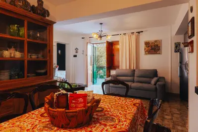 a living room with a table and a couch at Monia beach house in Santa Flavia
