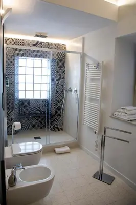 a bathroom with a shower and a toilet and a sink at Cassari 61 in Palermo