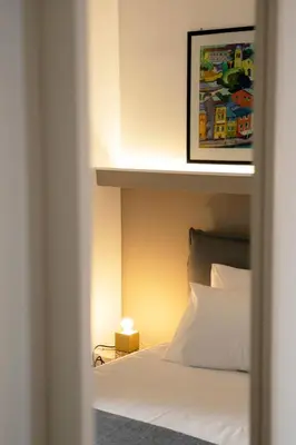 a bedroom with a bed with a light on it at Cassari 61 in Palermo