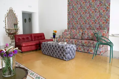 a living room with a couch and a red chair at Cassari 61 in Palermo