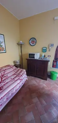 a bedroom with a bed and a dresser in a room at Anna&Miky beach house in Santa Flavia