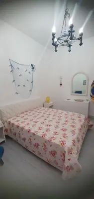 a bedroom with two beds and a mirror at Anna&Miky beach house in Santa Flavia