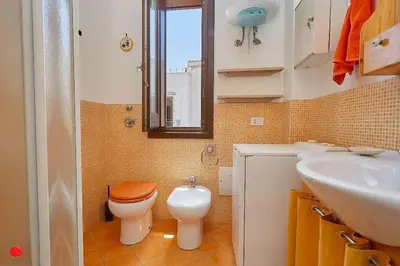 a bathroom with a toilet and a sink at Casa Dalila in San Vito lo Capo