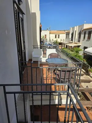 a balcony with a table and chairs and a table at Casa Dalila in San Vito lo Capo