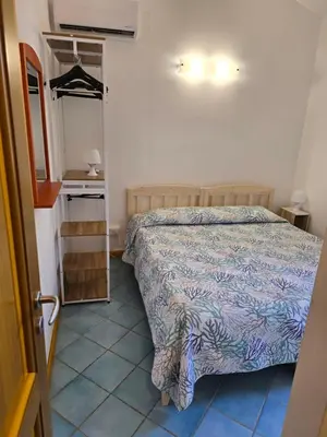 a bedroom with a bed and a dresser and a mirror at Casa Dalila in San Vito lo Capo