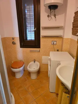 a bathroom with a toilet and a bidet and a sink at Casa Dalila in San Vito lo Capo