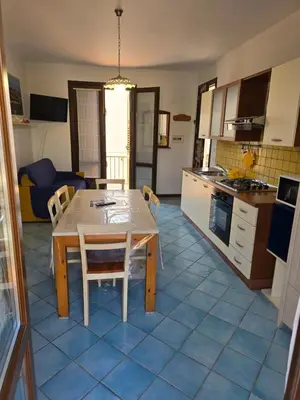a kitchen and dining room with a table and chairs at Casa Dalila in San Vito lo Capo
