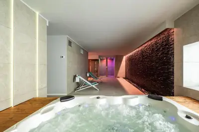 a bath tub in a room with a brick wall at Villa vista mare Piscina e SPA in Castellammare del Golfo