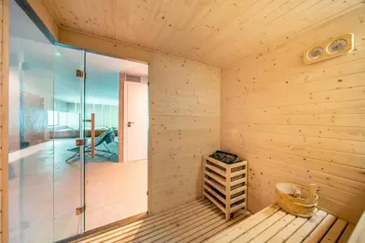 a sauna with wooden walls and a glass door at Villa vista mare Piscina e SPA in Castellammare del Golfo