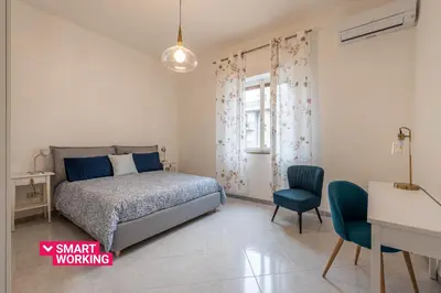 a bedroom with a bed and a desk and a chair at Casa Lincoln by Wonderful Italy in Palermo