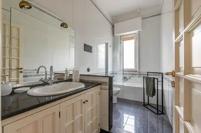 a white bathroom with a sink and a toilet at Casa Lincoln by Wonderful Italy in Palermo