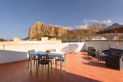 a patio with a table and chairs on a roof at Casa Serena in San Vito lo Capo