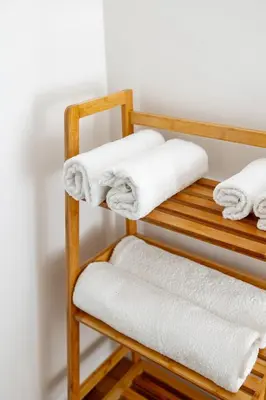 a wooden towel rack with white towels on it at Casa Gagini in Palermo