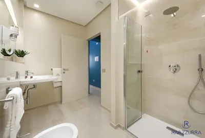 a bathroom with a shower and a toilet and a sink at Rivazzurra Beach Rooms in San Vito lo Capo