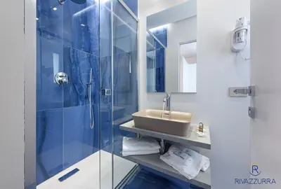 a bathroom with a sink and a shower at Rivazzurra Beach Rooms in San Vito lo Capo