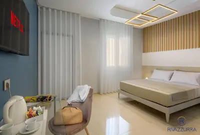 a bedroom with a bed and a tv in it at Rivazzurra Beach Rooms in San Vito lo Capo