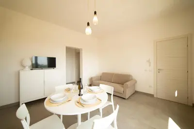 a kitchen and living room with a table and chairs at Blu Home Scopello in Castellammare del Golfo