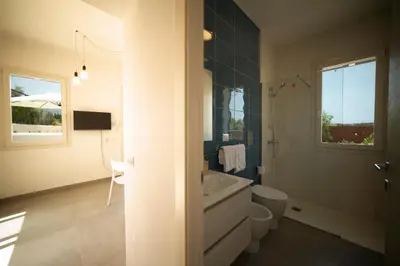 a bathroom with a sink and a toilet and a tub at Blu Home Scopello in Castellammare del Golfo