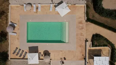 an overhead view of a swimming pool with a green screen at Blu Home Scopello in Castellammare del Golfo