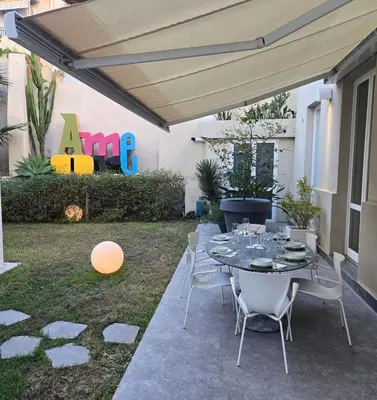 a patio with a table and chairs under a canopy at Casa Slide a Palermo in Palermo