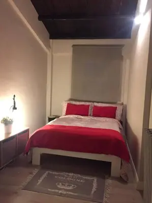 a bedroom with a bed with red blankets and pillows at Casa Allegra in Palermo