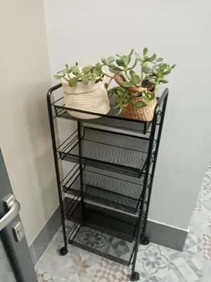 a black wire rack with plants on it at Casa Allegra in Palermo