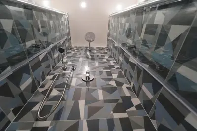 a bathroom with a black and white tile floor at Lovely Villa, close to the beach in Palermo