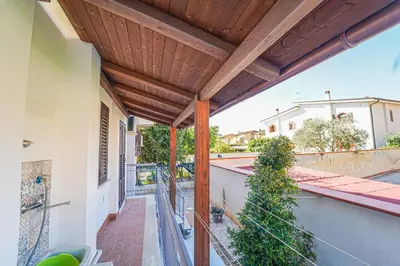 an outdoor patio with a wooden pergola at Lovely Villa, close to the beach in Palermo