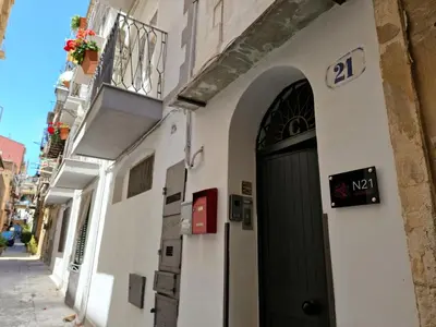 a kitchen with gray cabinets and a brick wall at N21 in Palermo