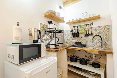 a kitchen with a microwave on top of a counter at Palermo home cathedral apartment in Palermo