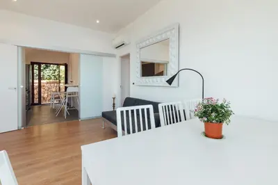 a kitchen and living room with a white counter top at Appartamento in Villa con accesso al mare, vista mozzafiato in Palermo