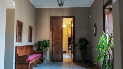 a living room with a couch and a door at Donna Guia suite in Palermo