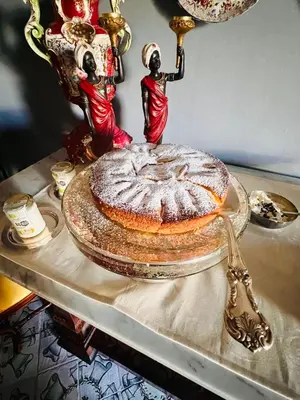 a cake sitting on top of a table with two figurines at Donna Guia suite in Palermo
