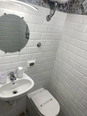 a bathroom with a sink and a toilet and a mirror at Maqueda Suite Palermo at Cathedral in Palermo