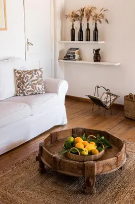 a living room with a table with a bowl of fruit at Tenuta dei Principi di Spadafora in Bosco Fraccia