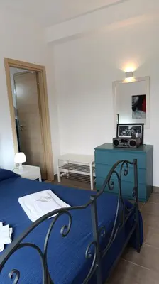 a bedroom with a blue bed and a mirror at Villa Casa di Franca - 700 meters from the sea Scopello in Castellammare del Golfo