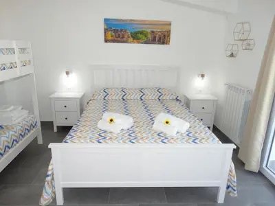 a bedroom with a white bed with two pillows on it at Villa Milicia - New Private Villa near Palermo and Cefalù with Pool, Sea View Terrace, Playground and Large Parking in Altavilla Milicia