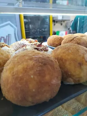 a bunch of donuts on a shelf in a bakery at La Loggia 34 in Palermo
