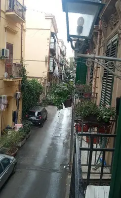 an alley with a car parked on a street at ZU' NICOLA in Palermo