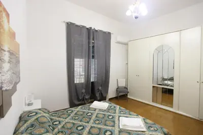 a small bedroom with a bed and a window at ZU' NICOLA in Palermo