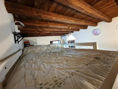 a large bed in a room with wooden ceilings at Old Town Loft - Palermo in Palermo