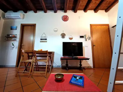 a living room with a tv and a table at Old Town Loft - Palermo in Palermo